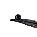 A polished black coin-edged screw-down crown for a watch, held by a pair of tweezers against a white background, top view
