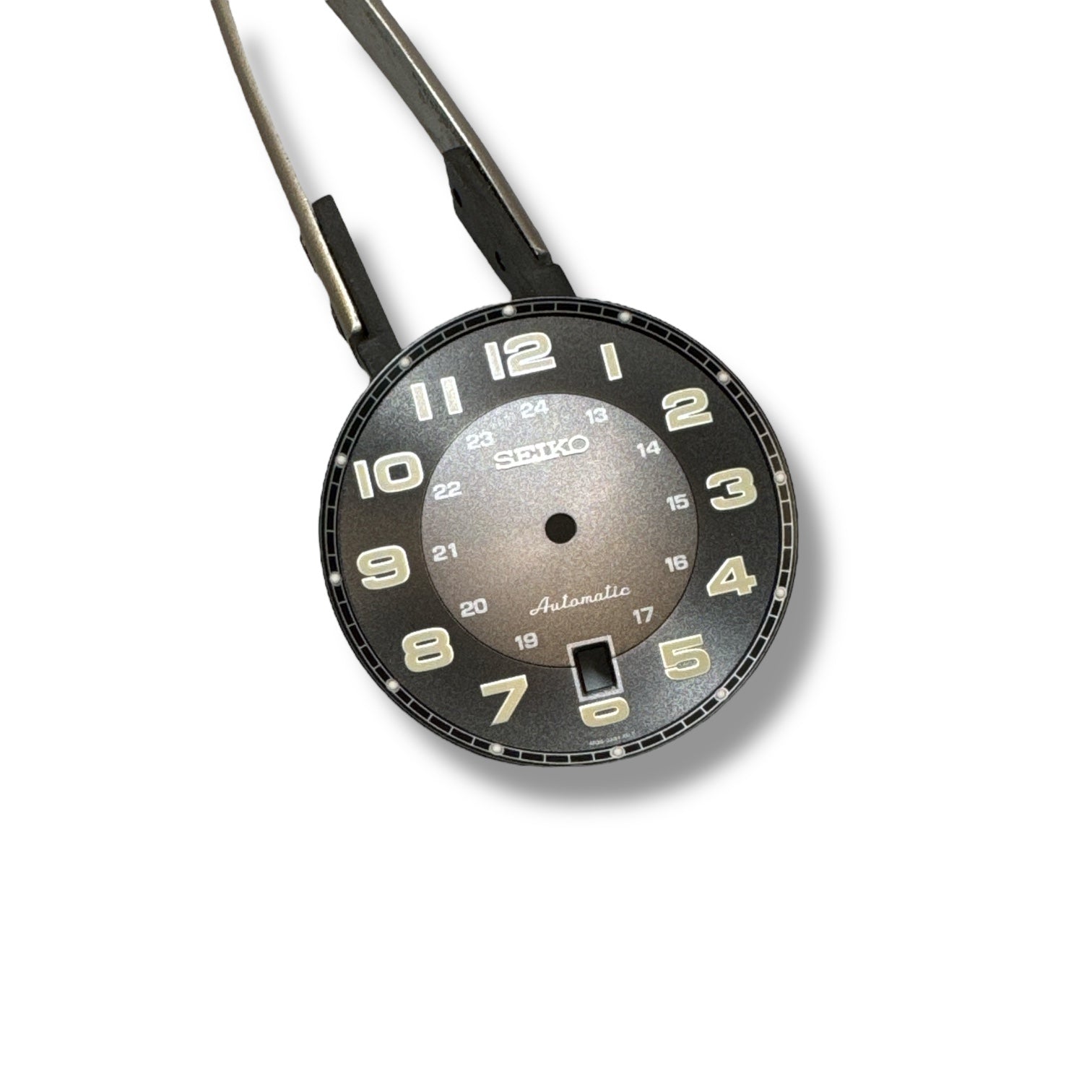 A Seiko SRPC89 OEM watch dial with black background, white numerals, and hands attached, against a white backdrop.