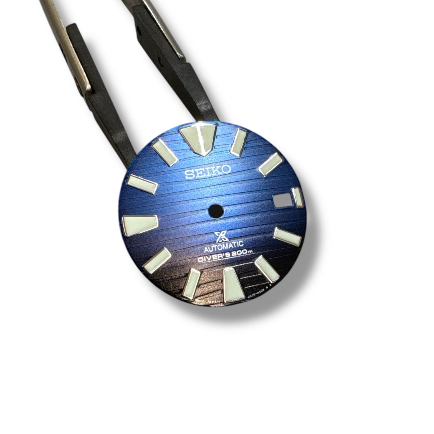 Seiko SRPC93 Samurai watch dial with blue fade to black color scheme and white hour markers.