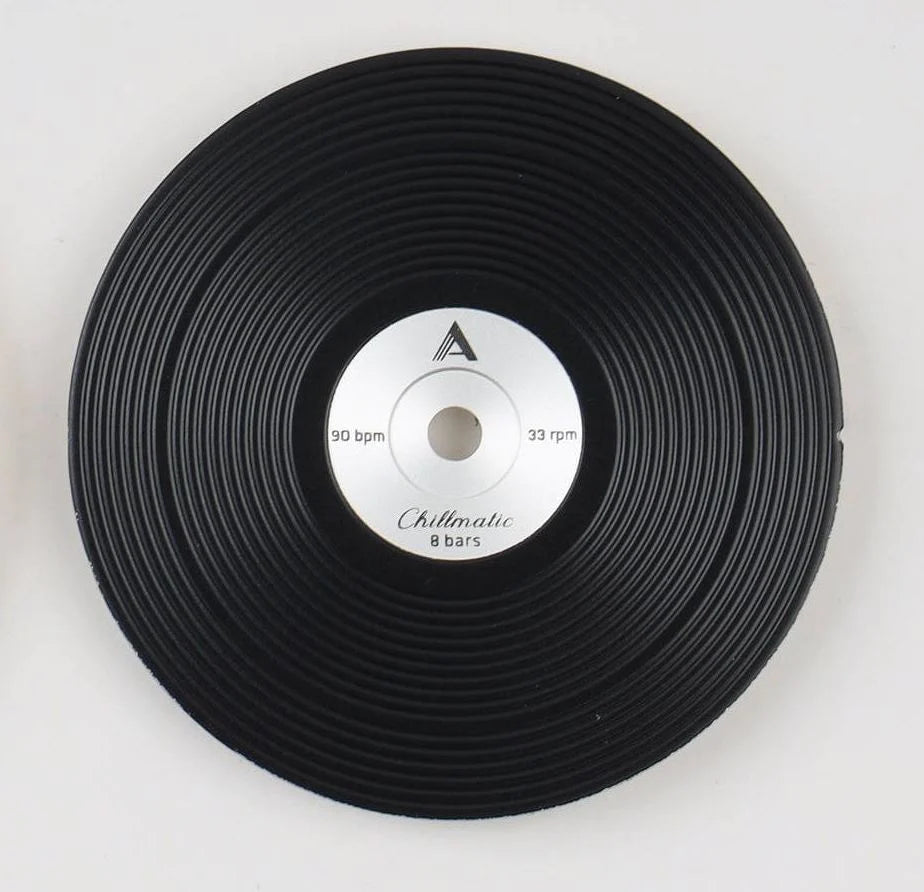1 vinyl record-style black watch dial lying flat on a surface
