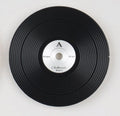 1 vinyl record-style black watch dial lying flat on a surface