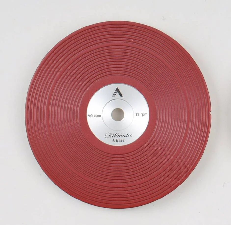 1 vinyl record-style red watch dial lying flat on a surface