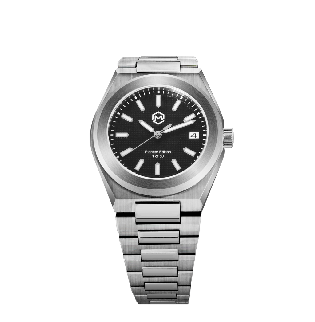 A silver-toned Project MM1 Pioneer Edition watch with a black waffle dial, stainless steel bracelet, and a vulcanised rubber strap.