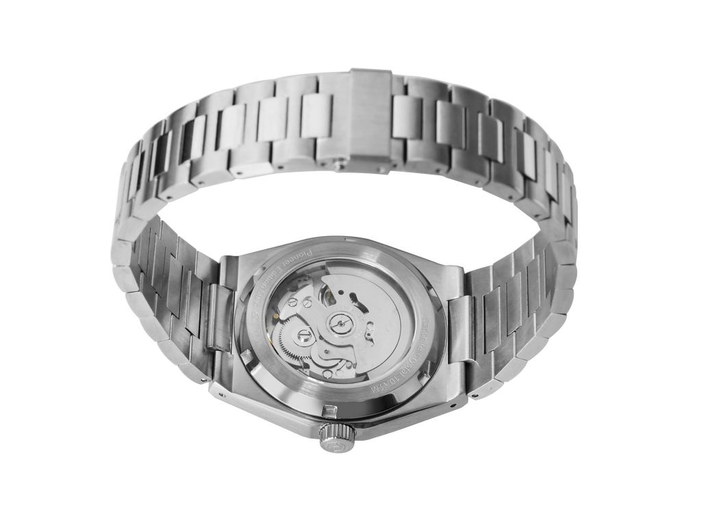 A silver-toned Project MM1 Pioneer Edition watch with a black waffle dial, stainless steel bracelet, and a vulcanised rubber strap.