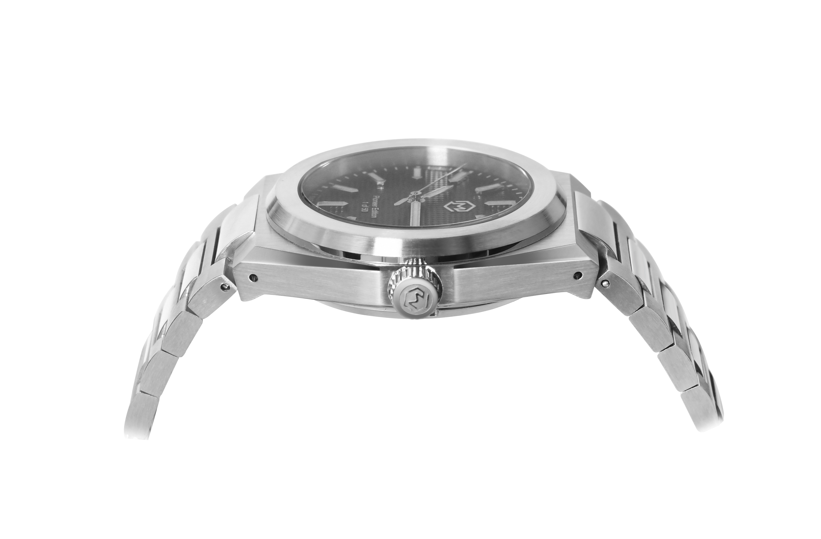 A silver-toned Project MM1 Pioneer Edition watch with a black waffle dial, stainless steel bracelet, and a vulcanised rubber strap.